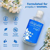 A blue bottle of Sliquid H2O Water-Based Lubricant from the brand Sliquid sits on a light surface next to delicate white flowers. This hypoallergenic formula is designed for sensitive women, with a pH balance of 4.0-4.4, and is glycerin-free, gluten-free, vegan-friendly, and sugar-free.
